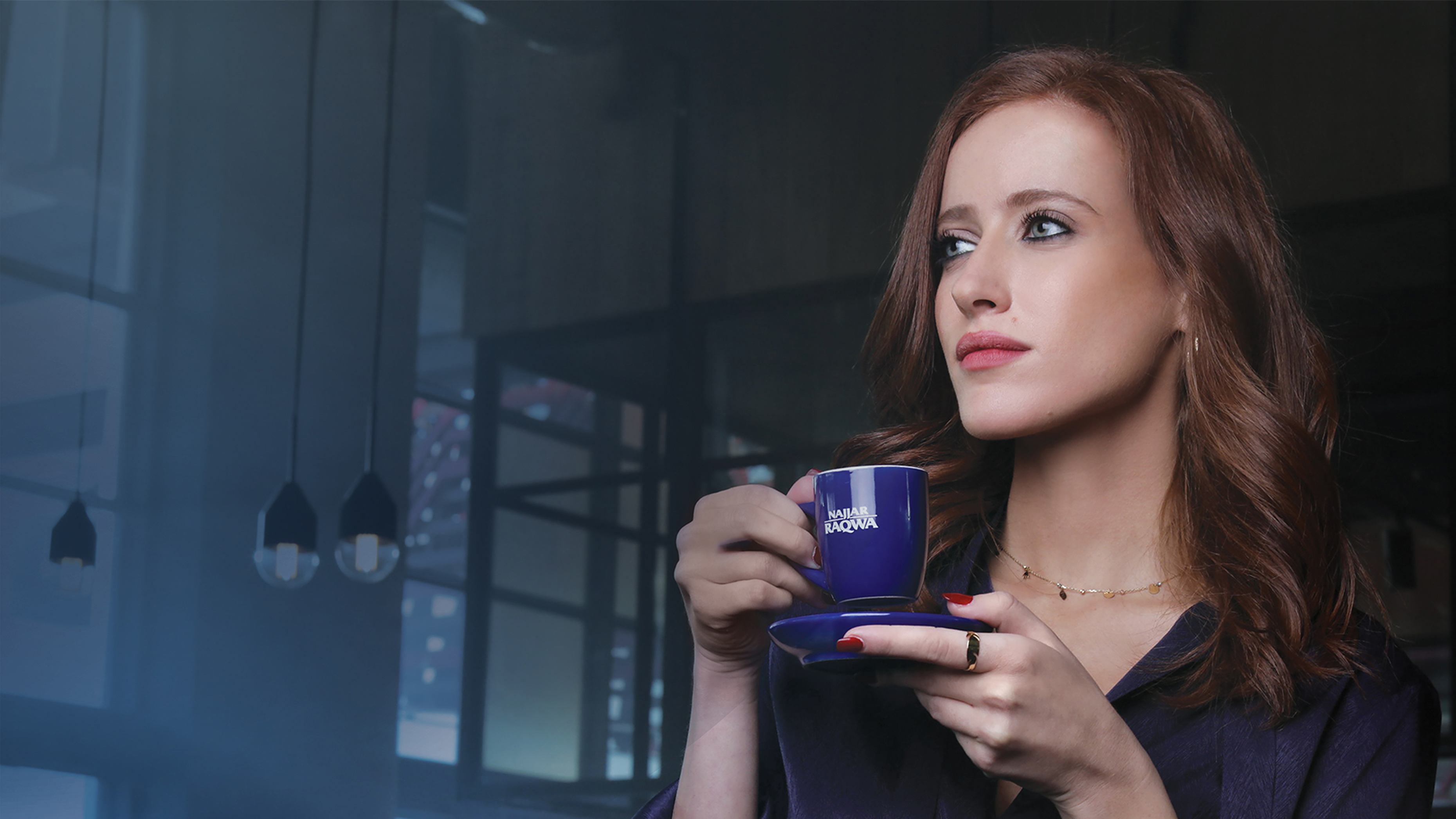 Woman drinking coffee from the Najjar Raqwa Q2 machine