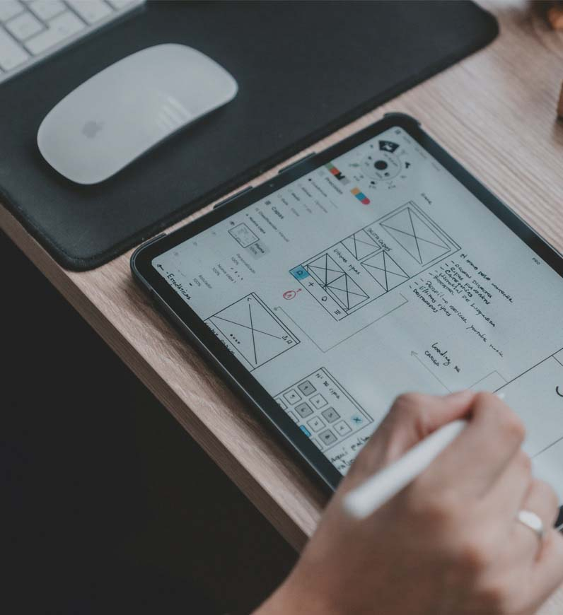 Designing a mobile website: Digital Transformation strategy, wireframes, brainstorming on laptop and tablet.